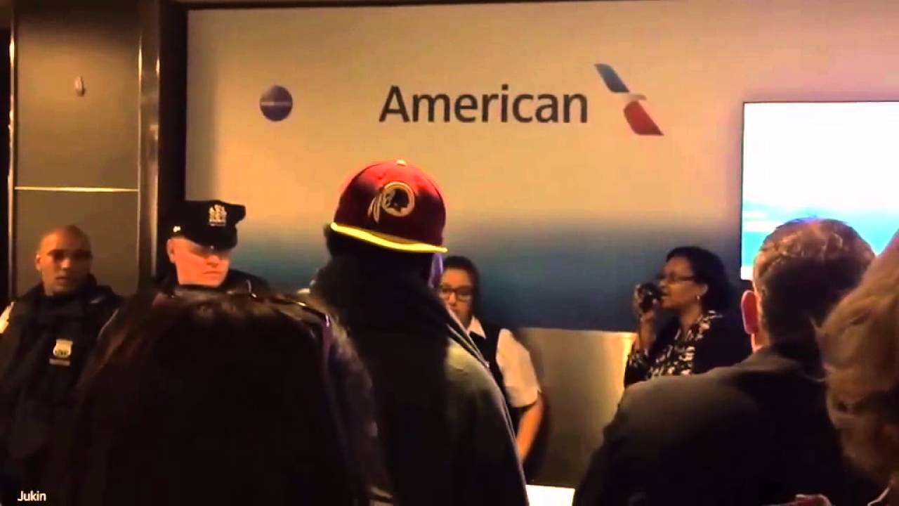 Frustrated people in airport confront the police after delays