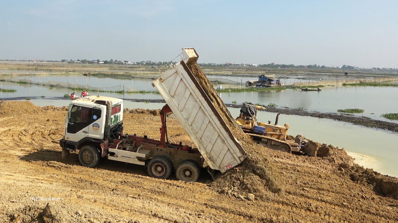 Huge Lake Filling Processing with Powerful Machinery Bulldozer and Dump Truck Spreading Dirt