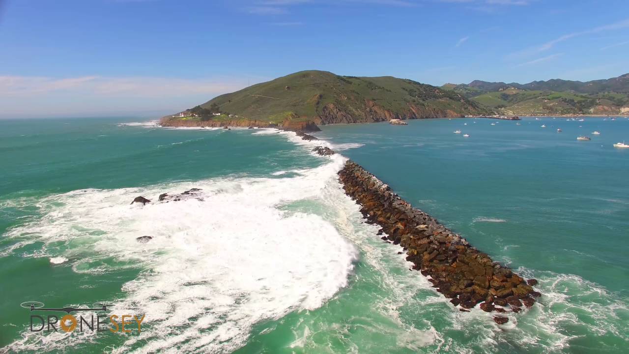 Big Waves Crashing Over a Jetty near a Lighthouse - Avila Beach