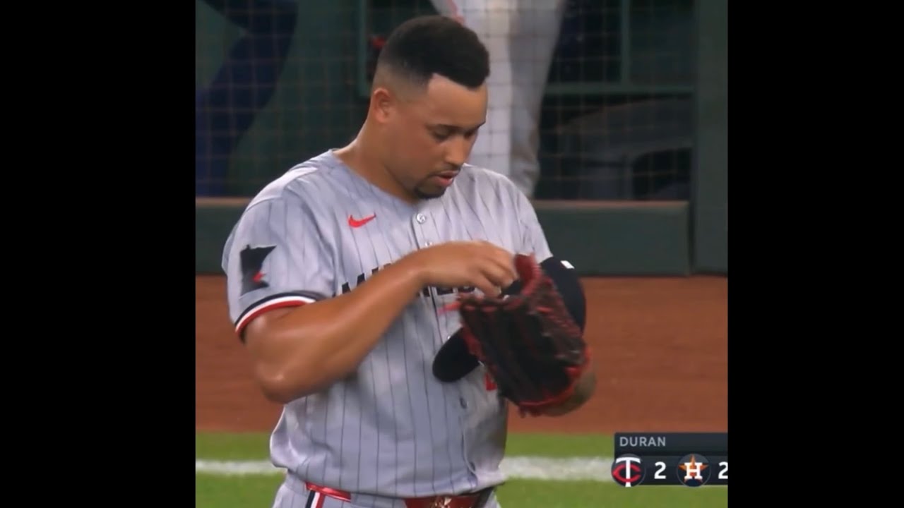 Jhoan Durán fixes the inside of his twins hat