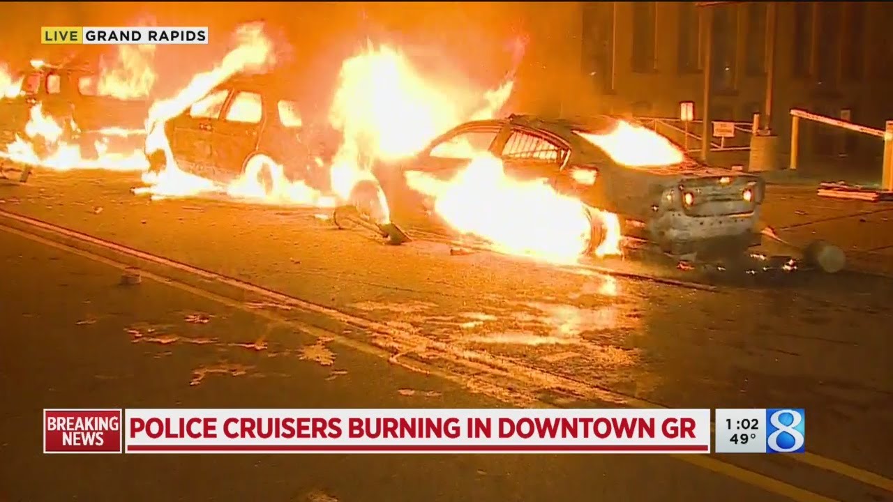 Police cruisers burning in downtown Grand Rapids
