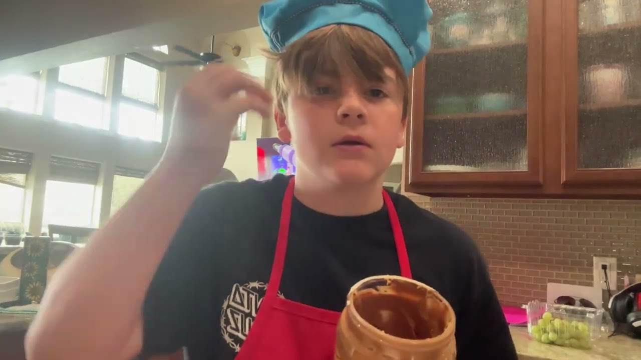 Kid cooks makes a peanut butter and jelly ￼