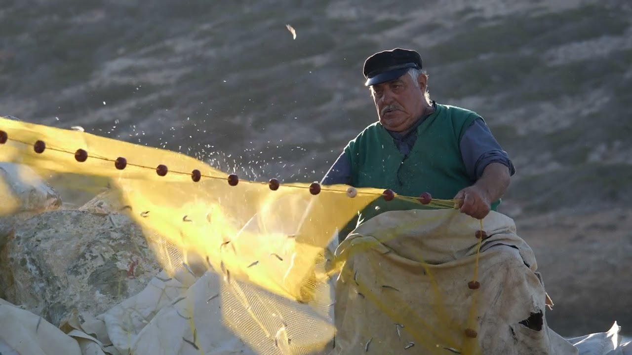 Amorgos greece older fisherman port untangling fishing nets slow motion 05 24