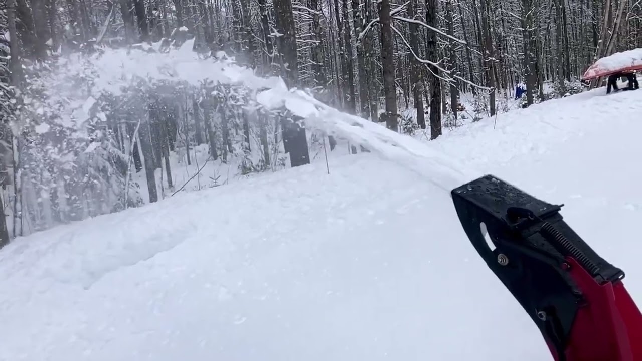 Slow motion of snowblower  throwing snow