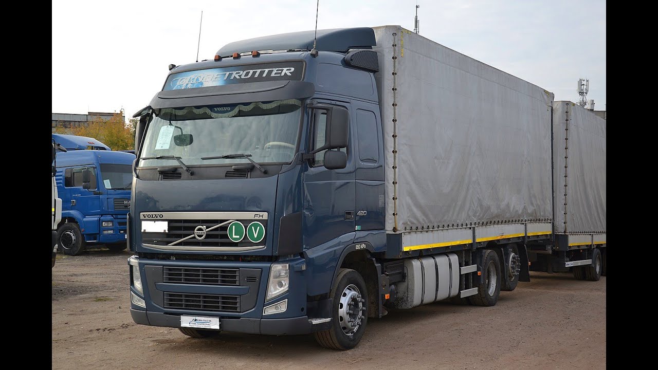 Обзор автопоезда. Бортовой-тентованный VOLVO FH TRUCK 6x2. Год выпуска 2013. В наличии!