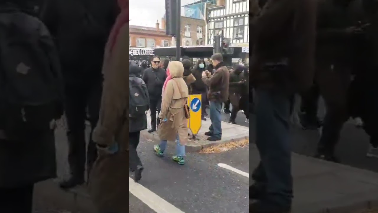 multiple masked men all in black have turned up at Whitechapel to counter protest the ukip protest