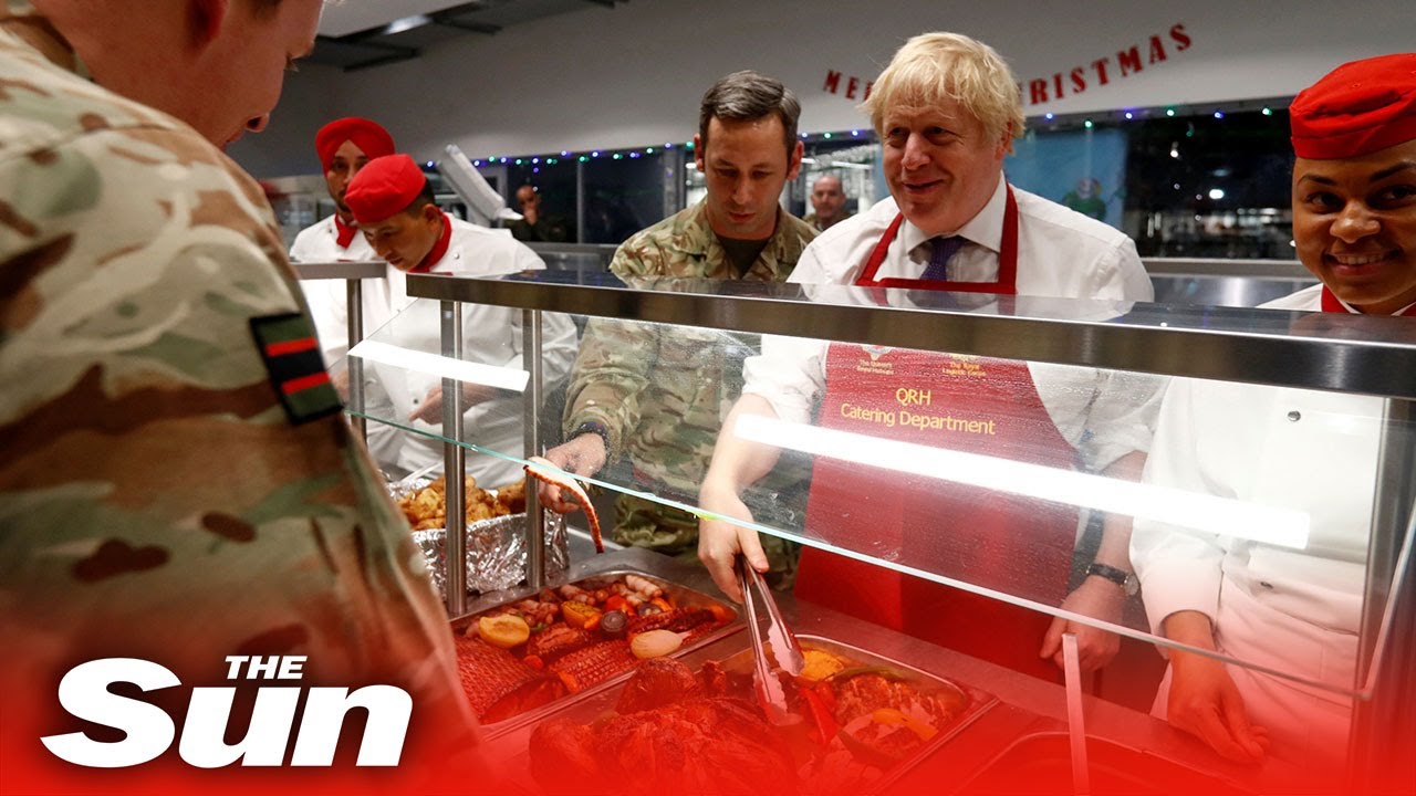 Boris Johnson serves Christmas lunch to British troops during a visit to a Nato mission in Estonia