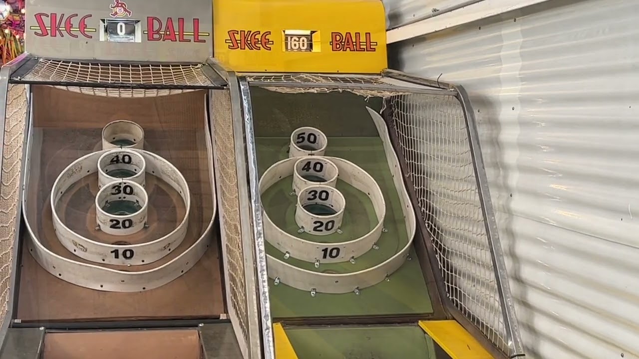 Nate and Beth playing old Skee Ball at an arcade