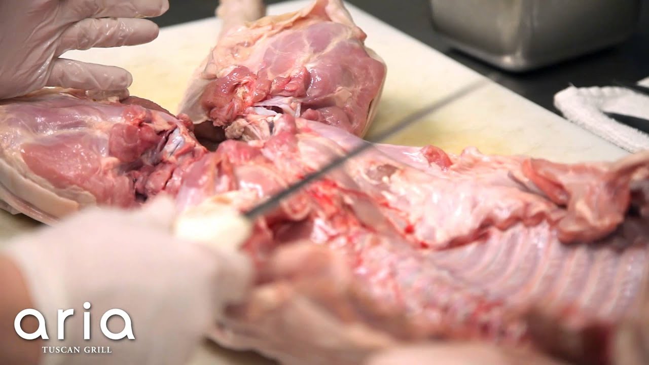 Chef Frank Altomare butchering a suckling pig