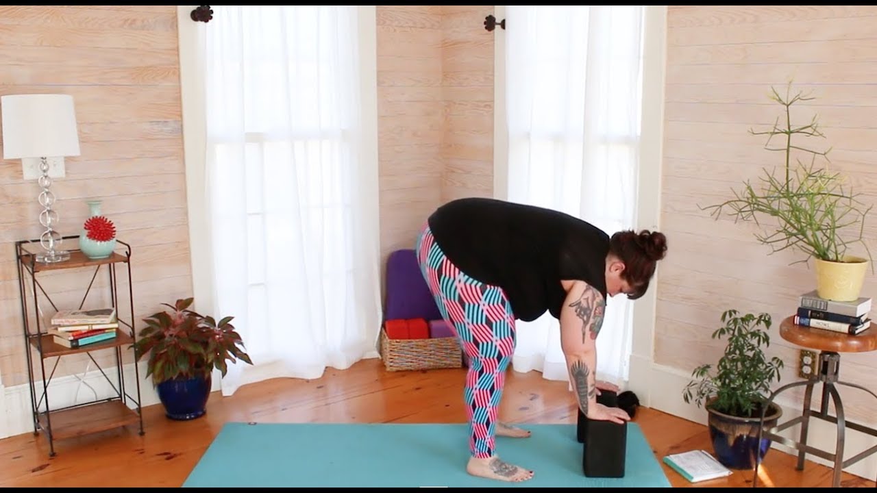 Forward fold modifications for larger bodies (Uttanasana)