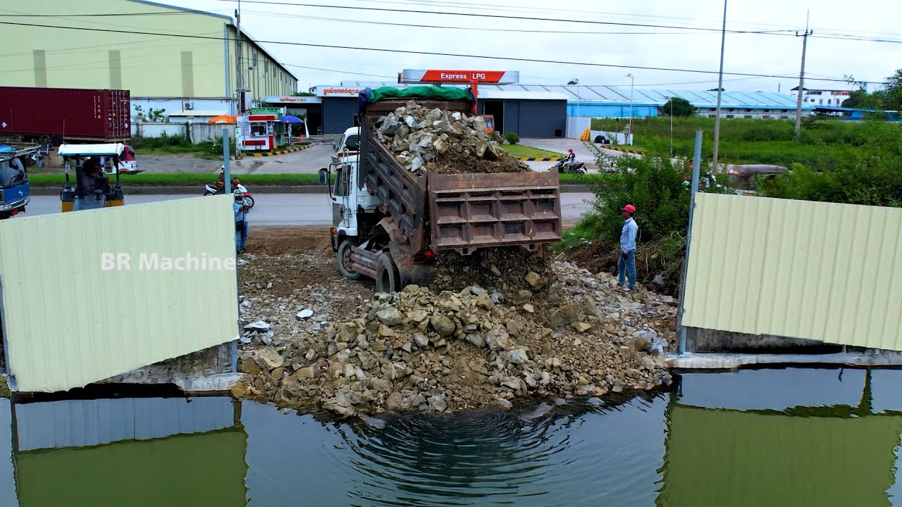 Amazing job with bulldozer D31P cooperate dump truck for filling the land flood by big stone