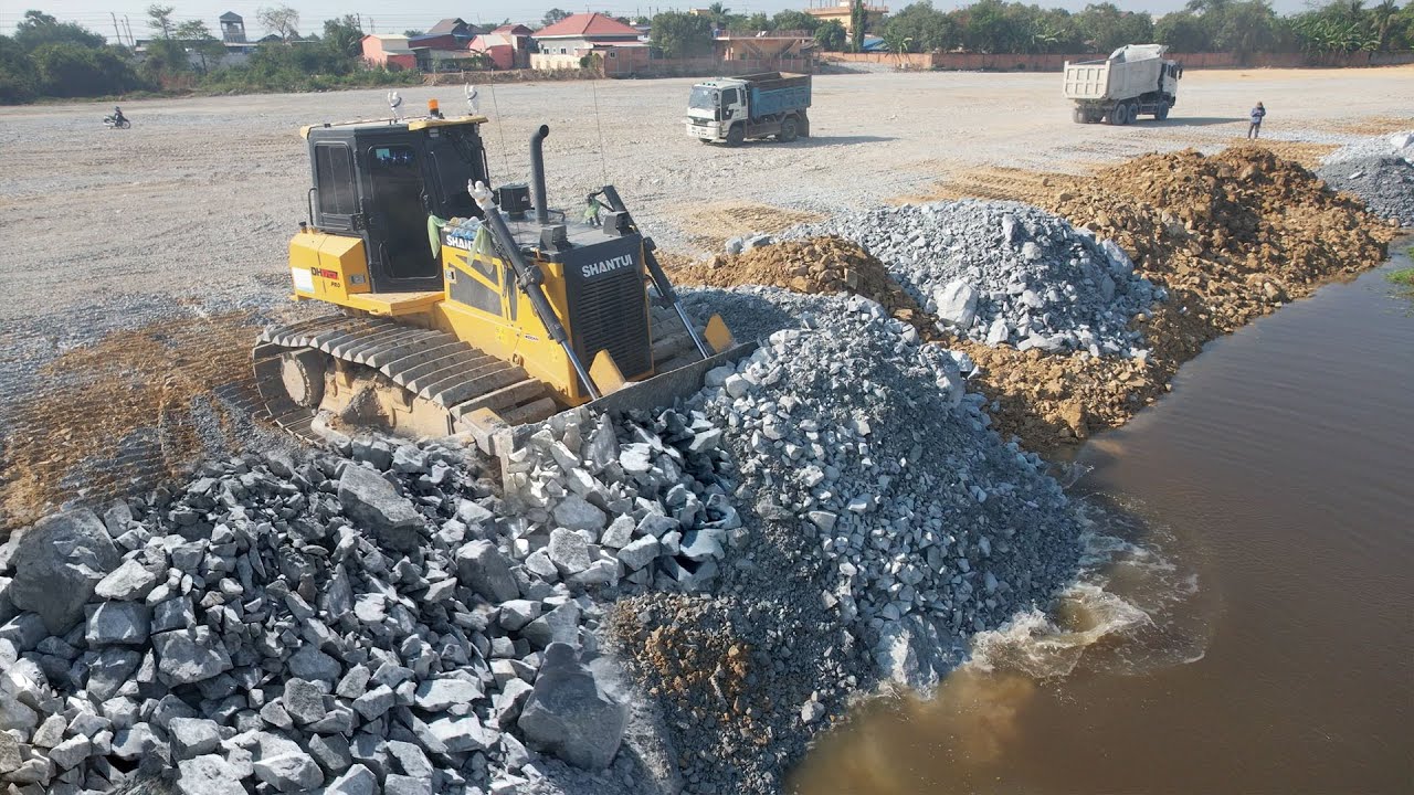 Landfill Stones work Buldozer Road on Water Using Skill  and Truck Unloading Stone Filling