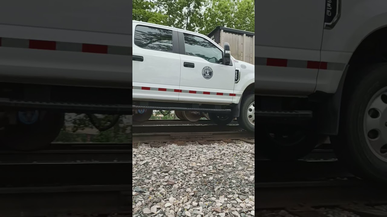 Ford truck driving on rail road tracks