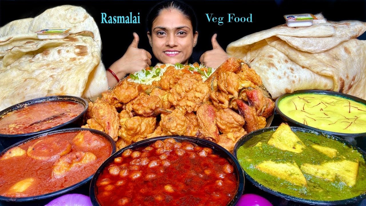 Eating Chole Masala, Palak Paneer, Dum Aloo, Dal, Rasmalai, Gobhi Pakoda, Butter Naan, Fried Rice 