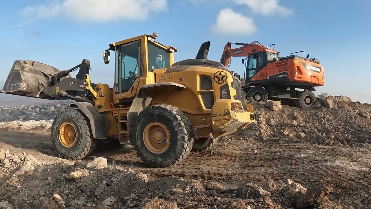 Volvo Loader Working Alongside Another Excavator on Site
