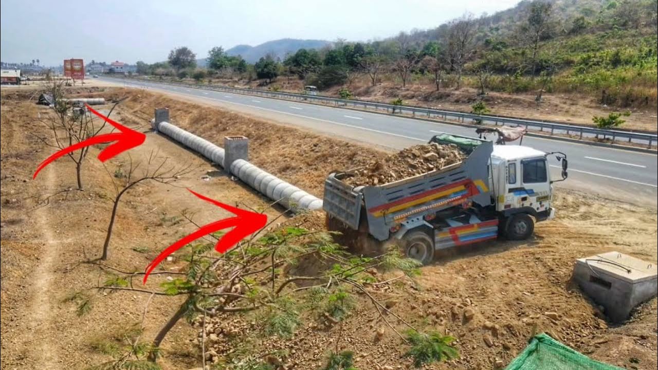 Dropping soil bury drainage system next to the road. Drivers passing by must be very careful.