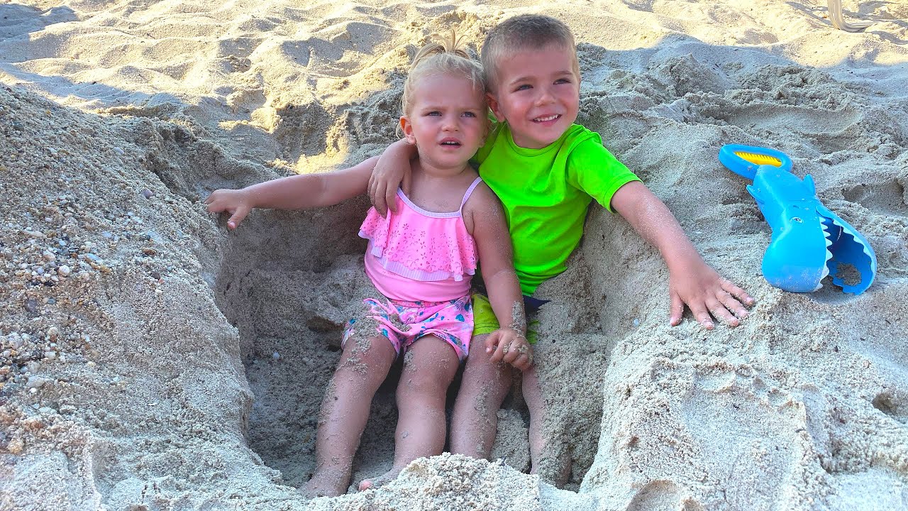 Mike and Emy are playing on the beach
