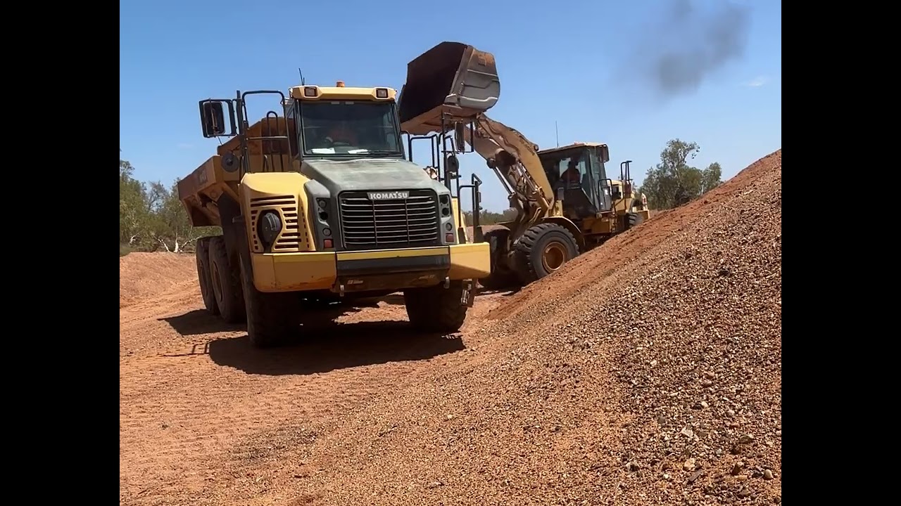 Front End Loader loading moxie in river 