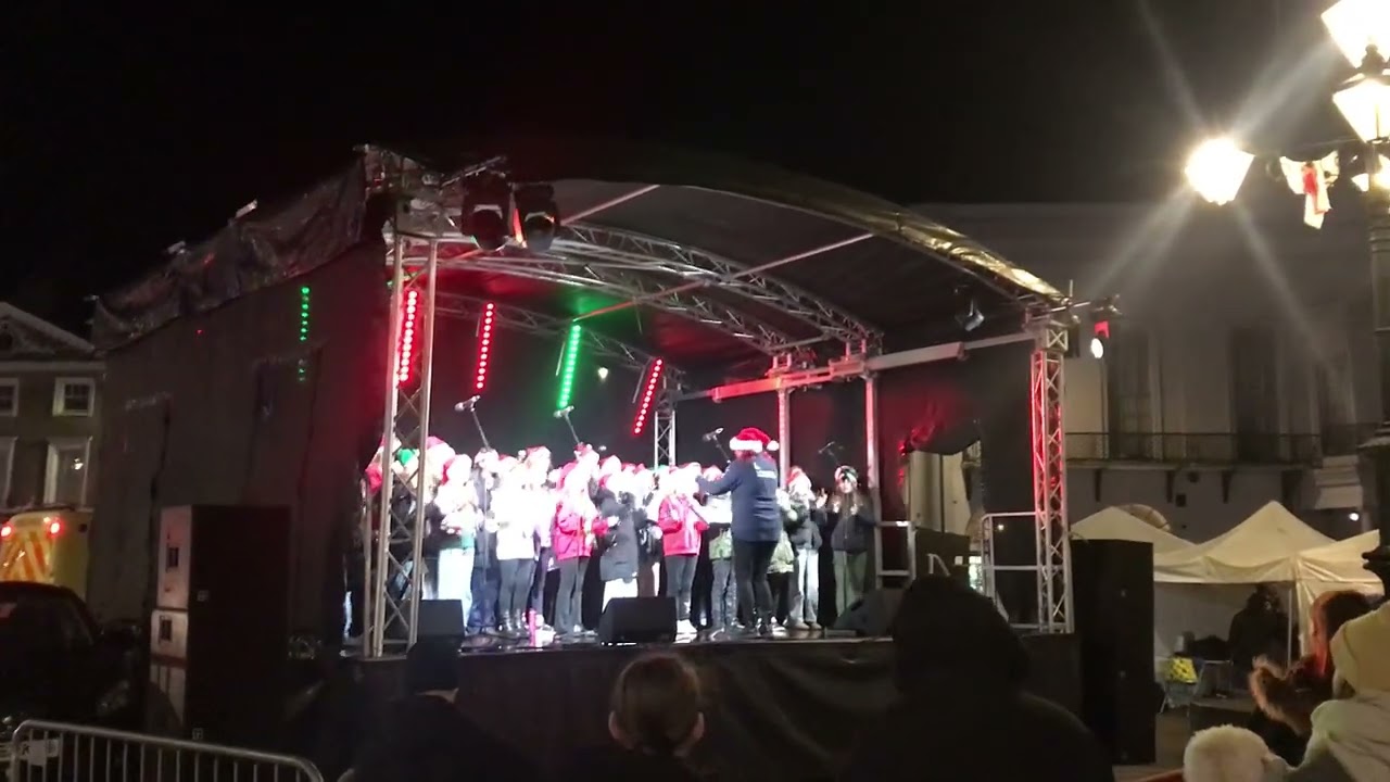 A community choir school group singing 'Do they know it's Christmas?' in 2025