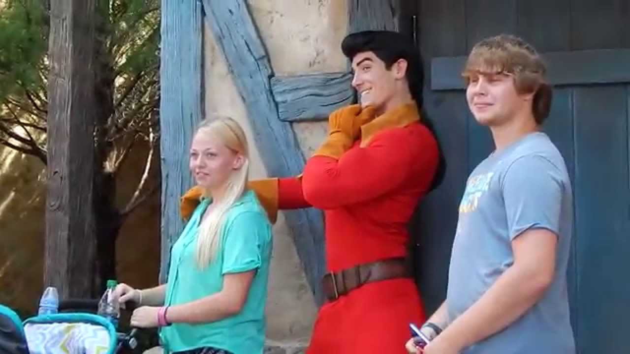 Belle grabs a book from GASTON at Disney World Magic Kingdom