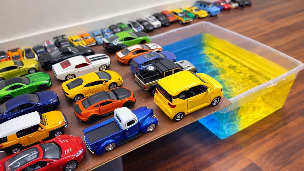  Various Diecast Model Cars Crashing Into The Blue Water
