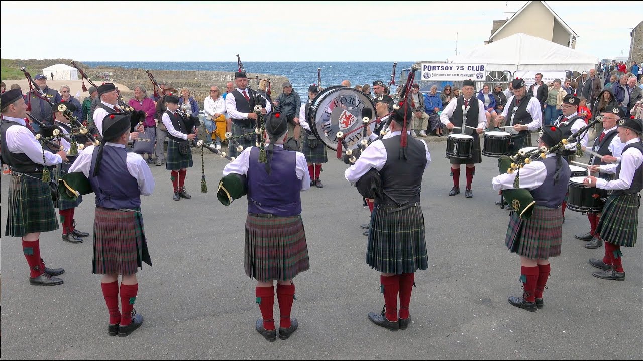 Scotland the Brave set by Portsoy Pipe Band on Old Harbour during 2023 Portsoy Boat Festival