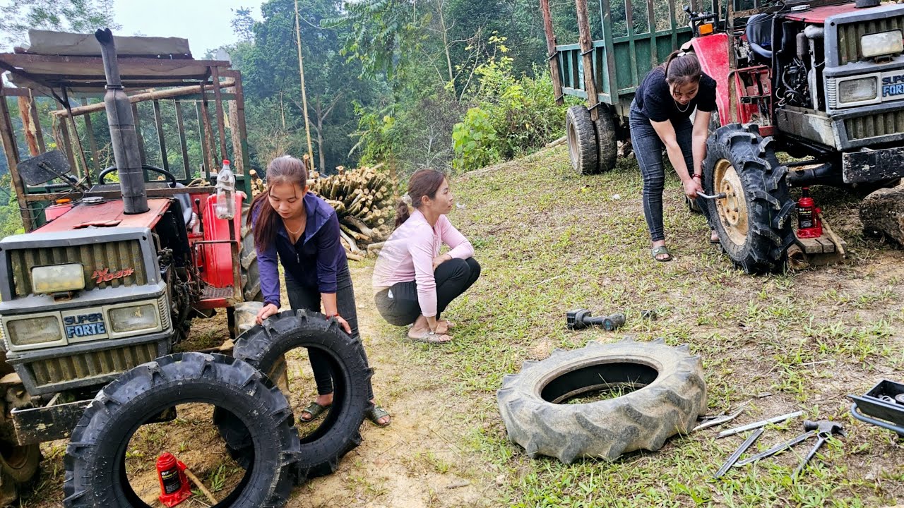 The girl went to change the tire of the village car to carry wood for the neighbor.- repair girl