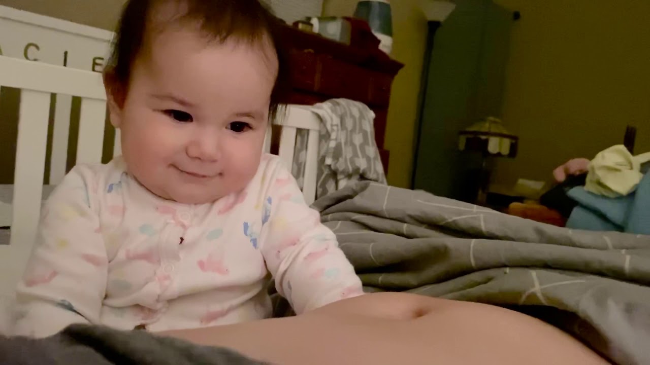 Entertaining 8 month old baby with mom’s belly