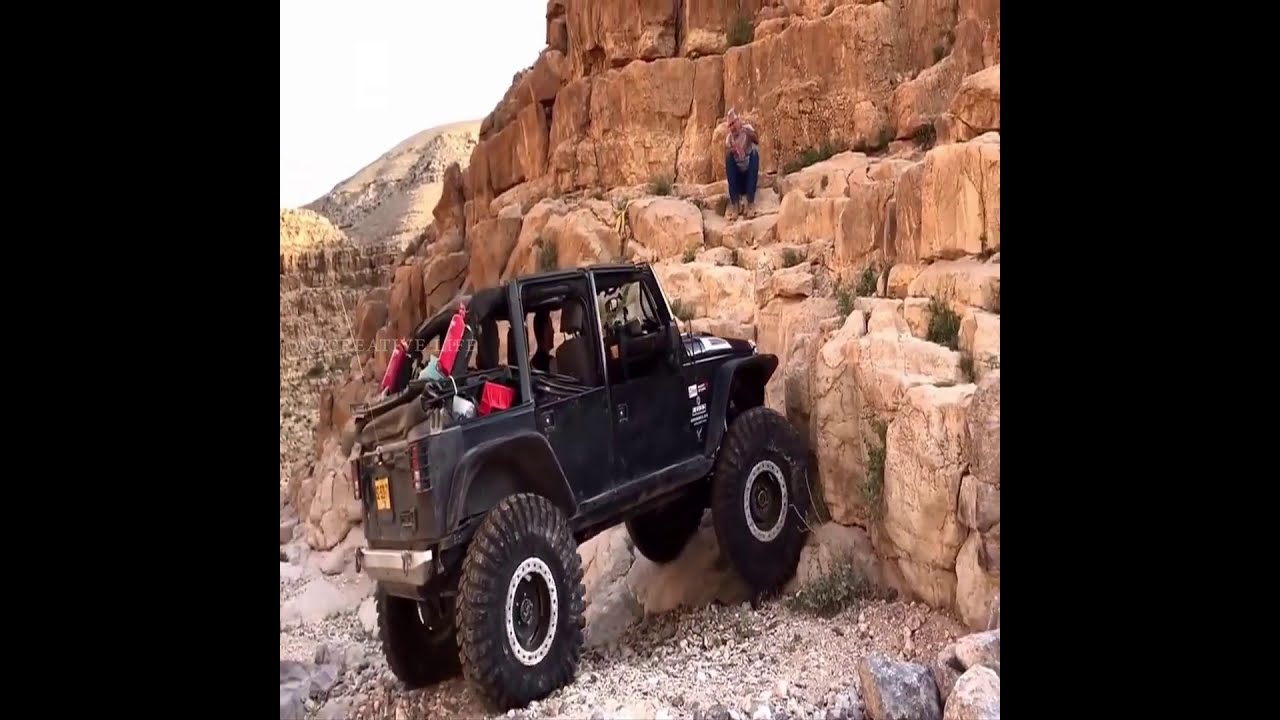 تحدي القوه الصعاب  Off-road vehicle climbing the cliff