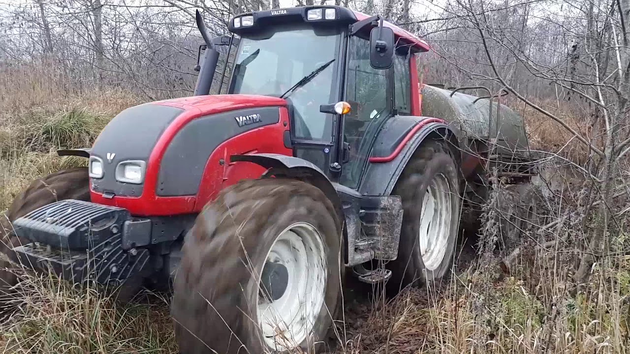Valtra stuck in mud with water barell