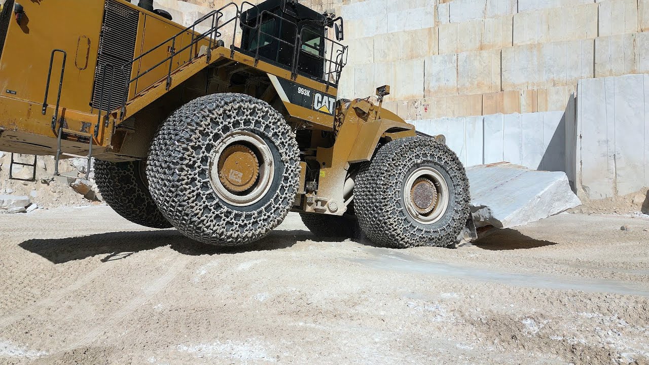 CAT 993K Loader proving its worth against huge marble block