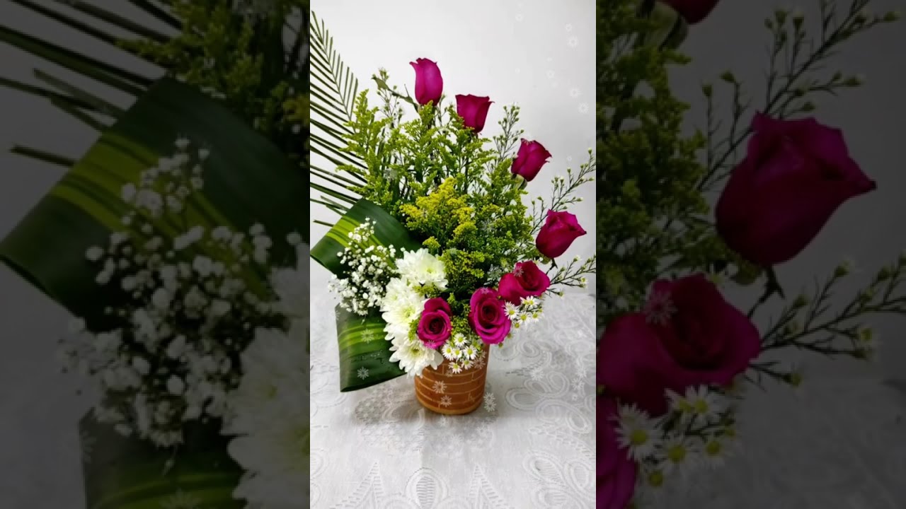 arrangement with palm and roses