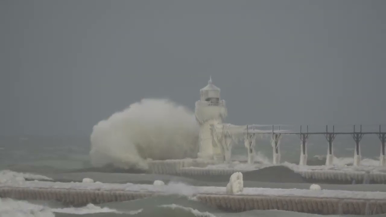 Powerful Waves Smash Against Frozen Lighthouse on Lake Michigan