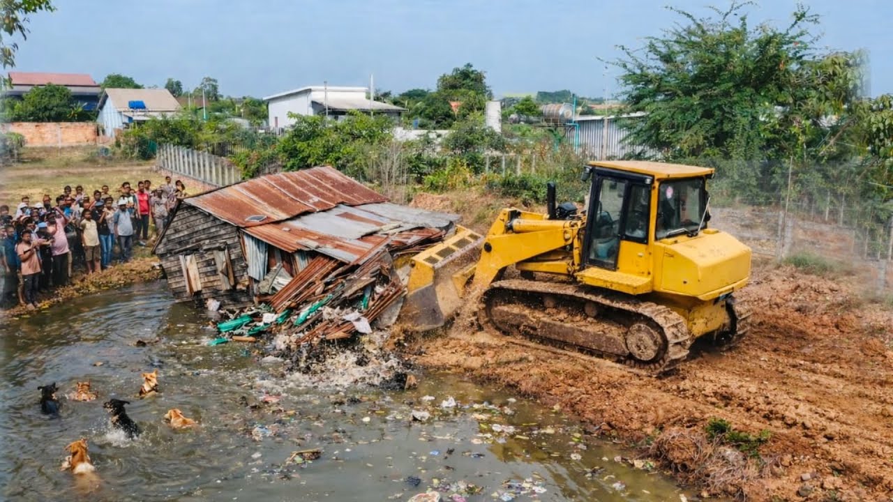 Great new project!! Complete 100% clearing, pushing soil, garbage in water the houses by Bulldozer