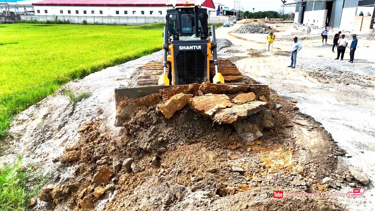 Powerful Strongly Skilled Shantui Dozer Clearing Up Stones & 25 Ton Dump Trucks Landfill Foundation