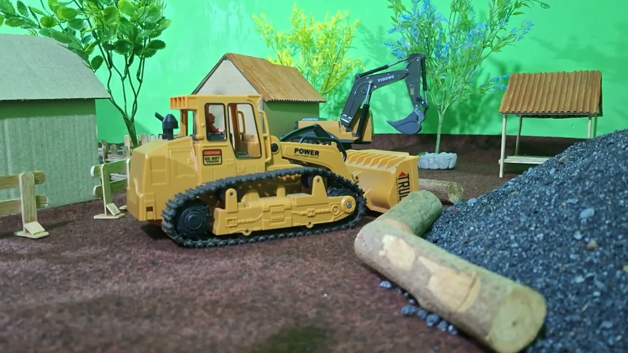 Buldozer membantu excavator untuk menata kayu