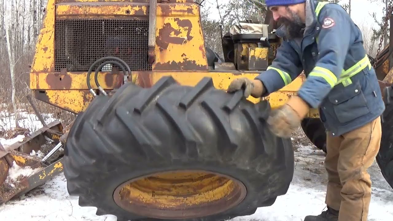 International paylogger skidder tire trouble out in the bush; video 1 of 2
