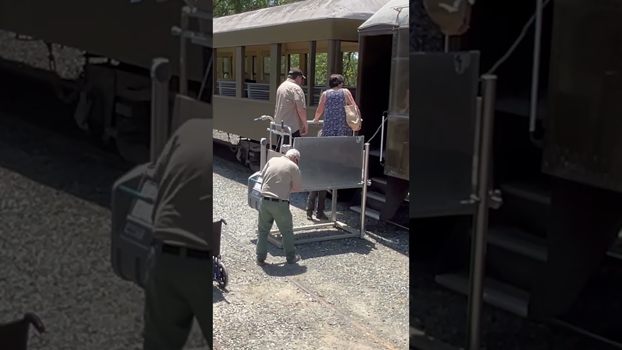 DISABLED MAN GETS ASSISTANCE BOARDING THE TRAIN AT RAILTOWN 1897