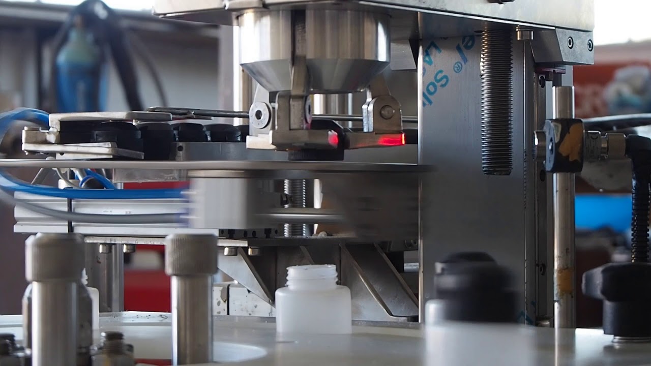 Capping machine with gripper and servo motor