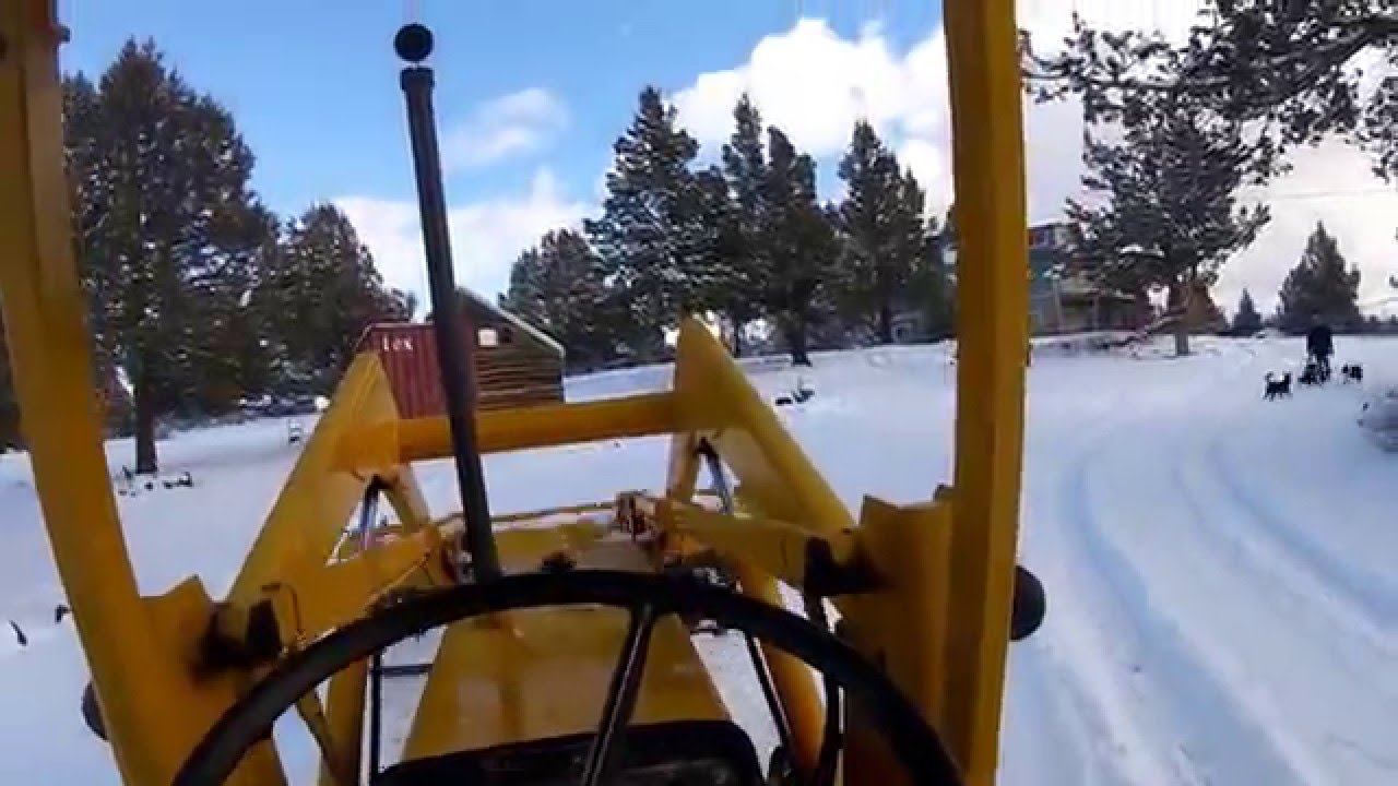 Backhoe Plowing Snow