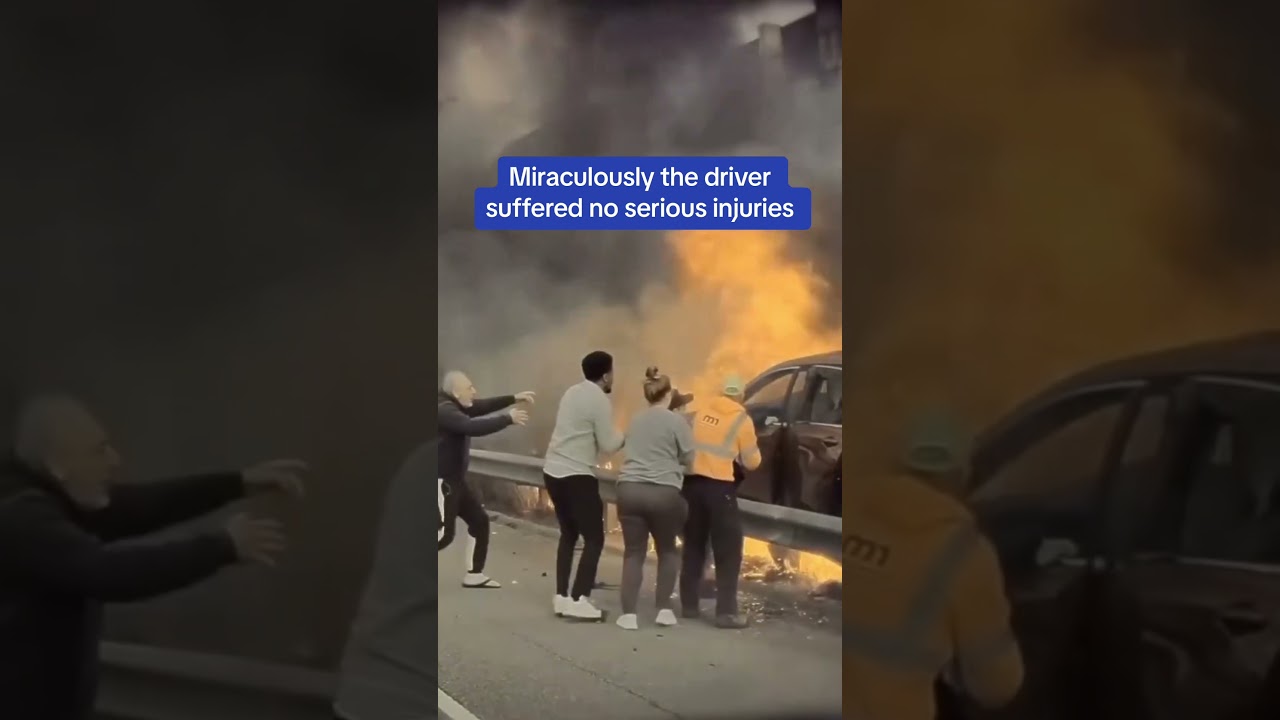 Terrifying moment a man is saved from a burning car
