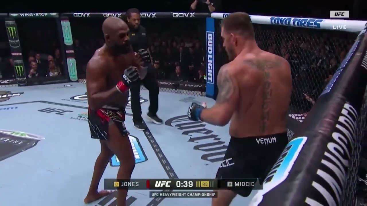 Jon Jones finishes Stipe with a spinning back kick to the body