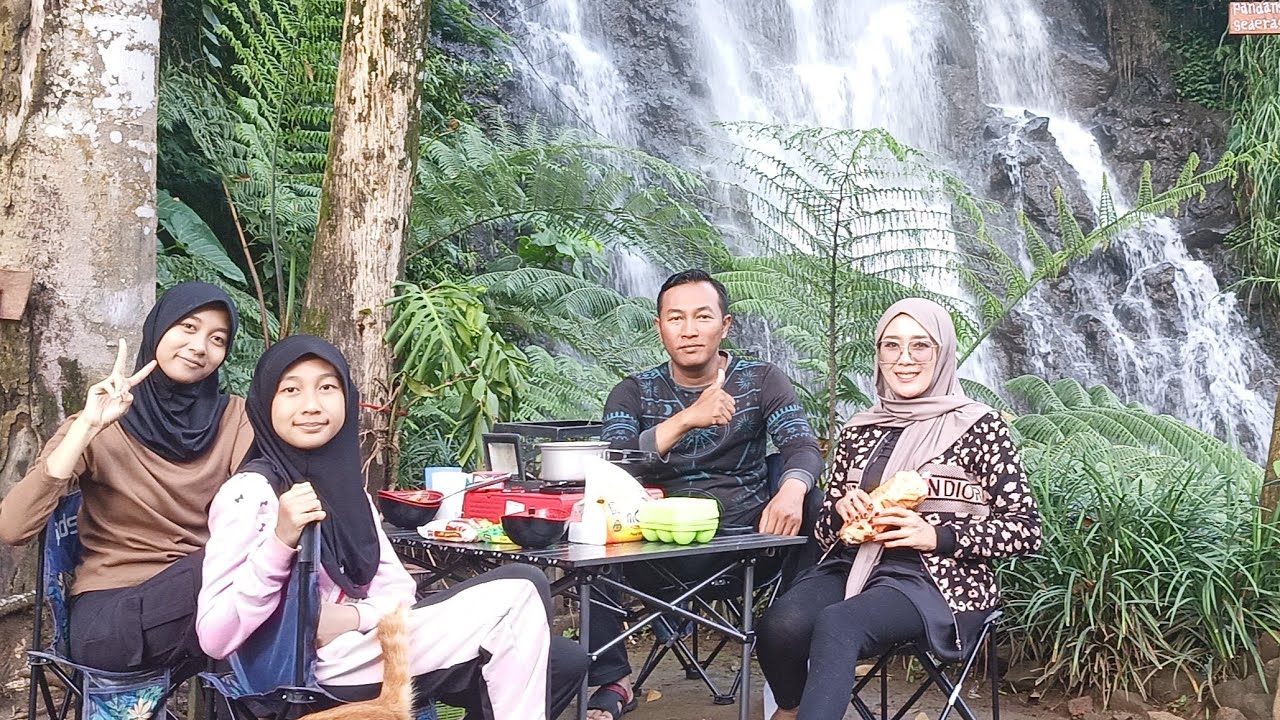 Family camping on the edge of the Ngargoyoso waterfall