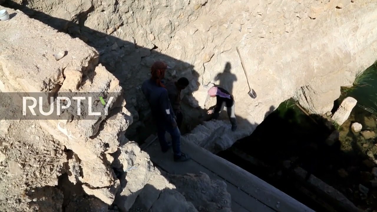 Archaelogical workmen try to restore Afqa spring