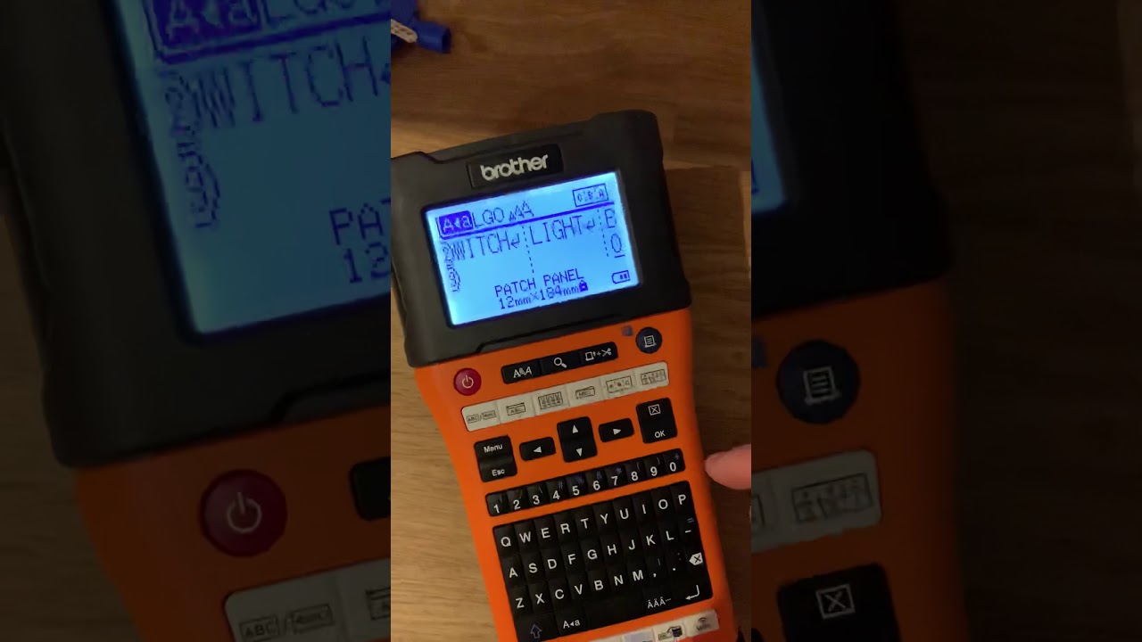 Electrician labelling a consumer unit using the Brother EW550 P-Touch printer without the APP