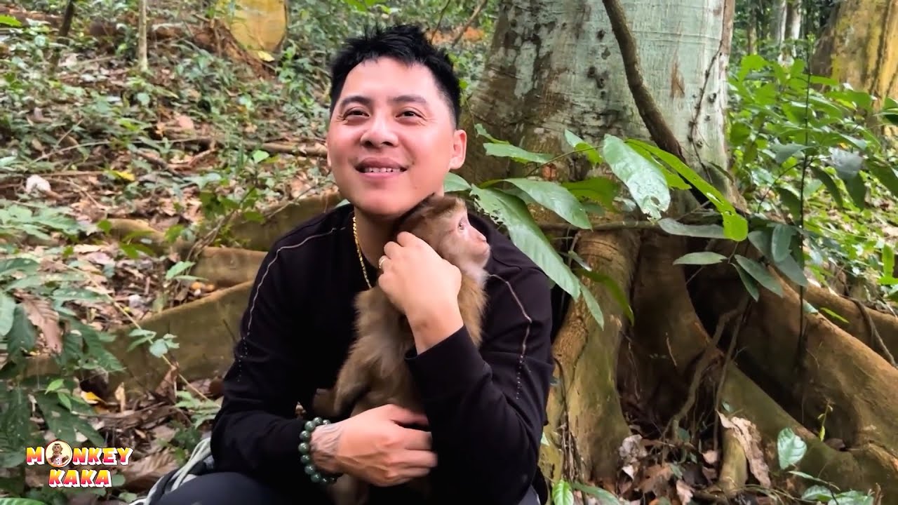 Kaka the monkey cuddles with his father so affectionately