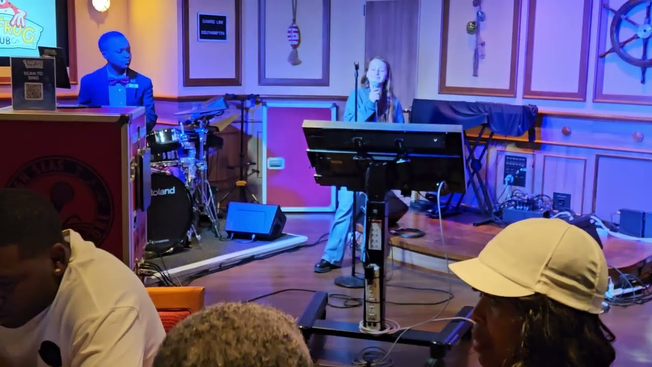 Amber singing karaoke to Jolene on the Carnival Legend. 