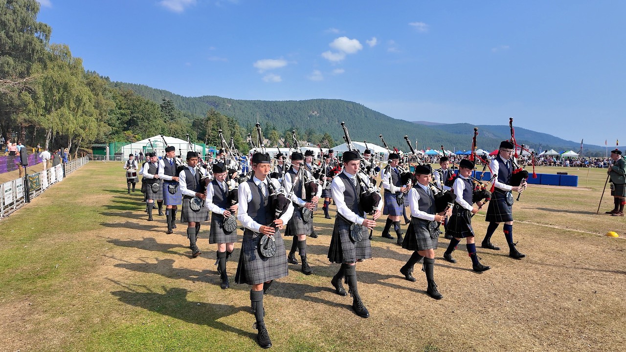 Granite City & Lathallan School Pipe Bands march out playing My Land at 2025 Ballater Highland Games