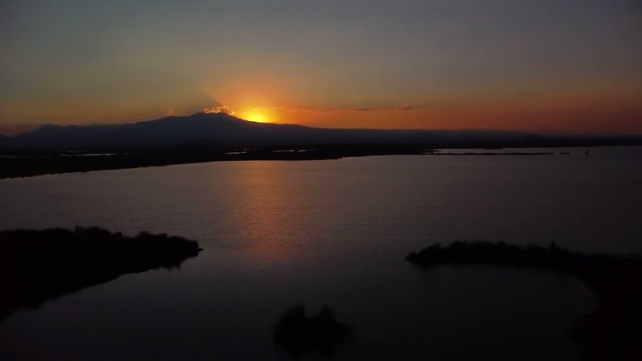 🌅 Sunset Serenity: Drone Footage of a Lagoon in a Mountain Landscape | Aerial Tranquility 🌄