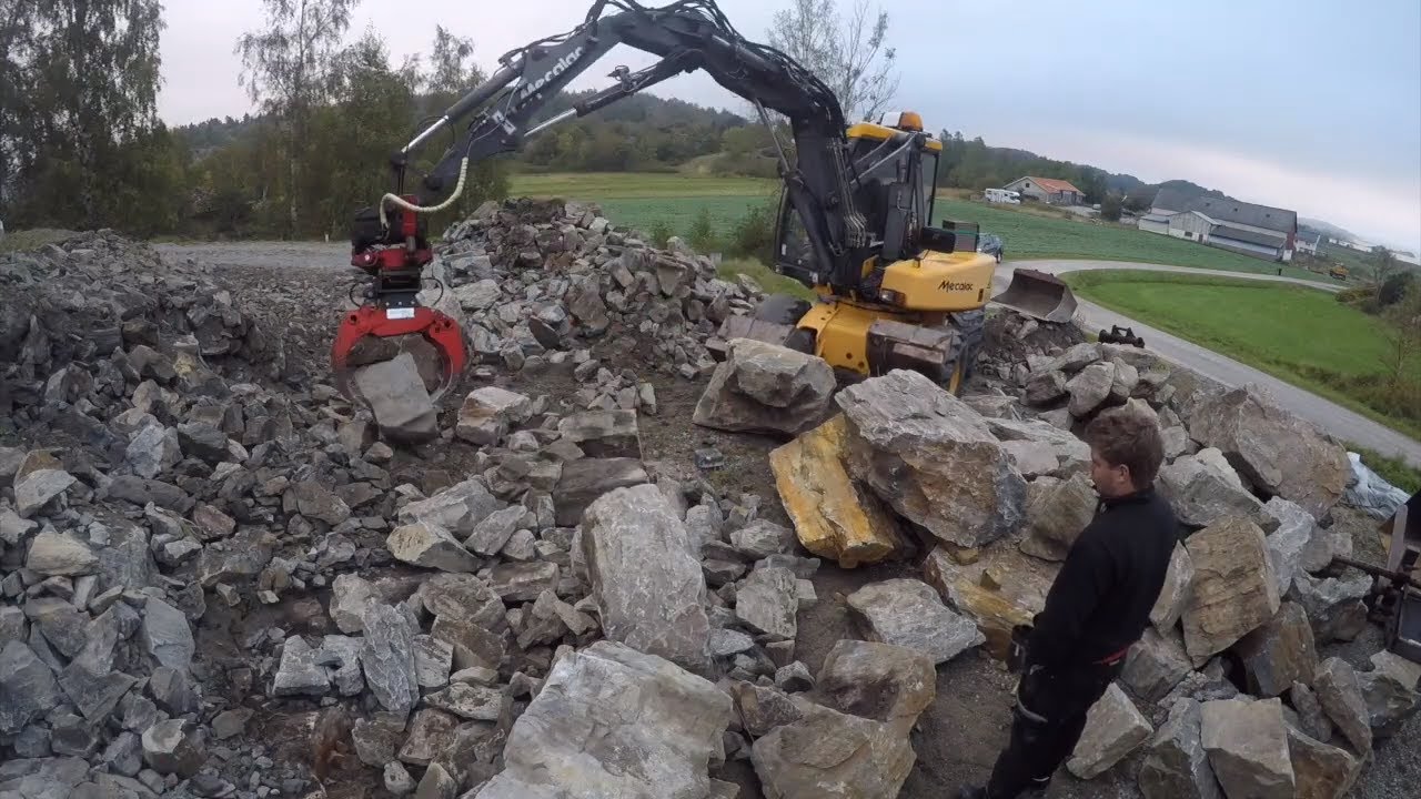 Blasted stone wall - BUILT WITH MECALAC 12MXT